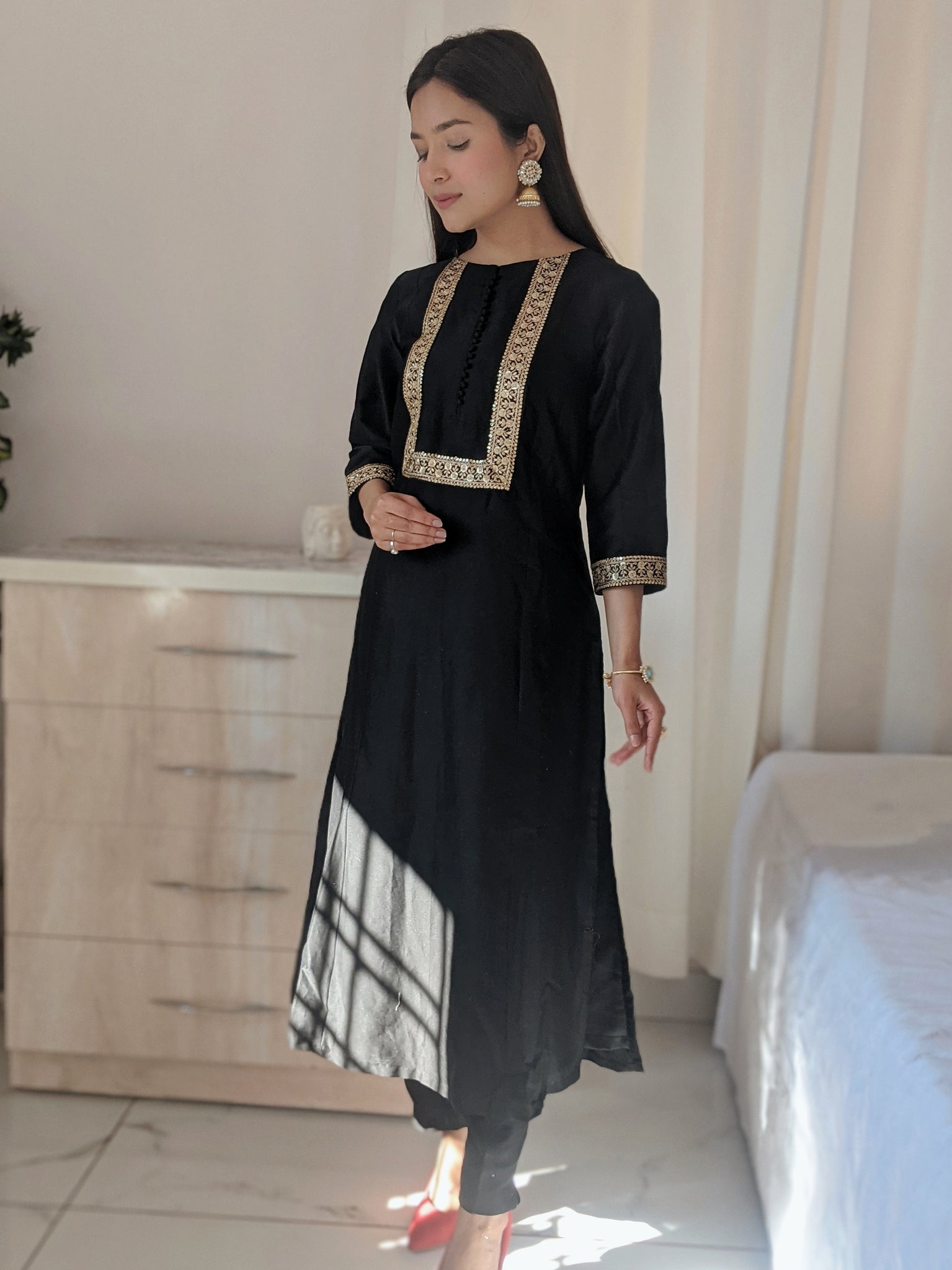 Black Silk Anarkali Kurta paired with pants.