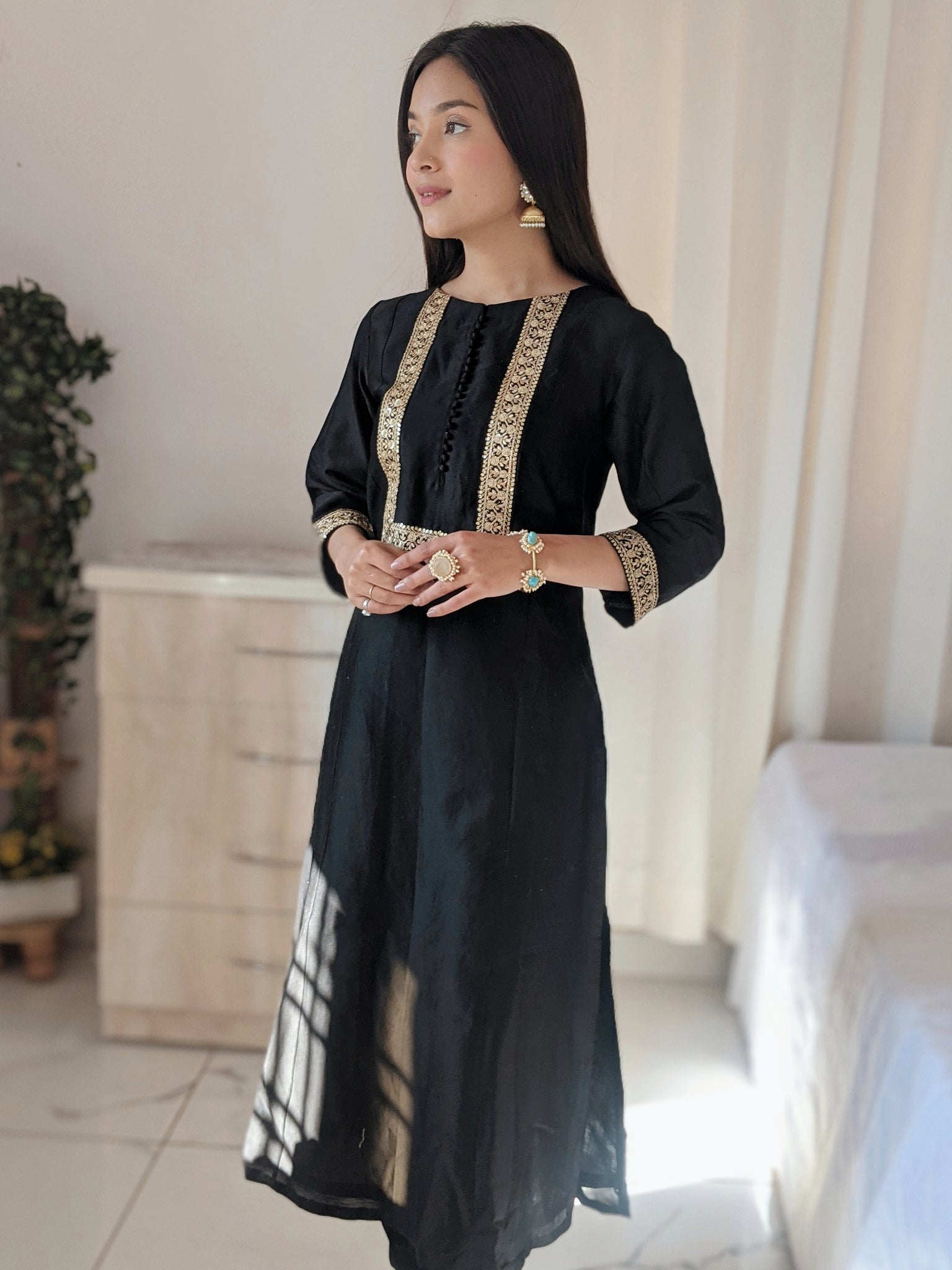 Black Silk Anarkali Kurta paired with pants.