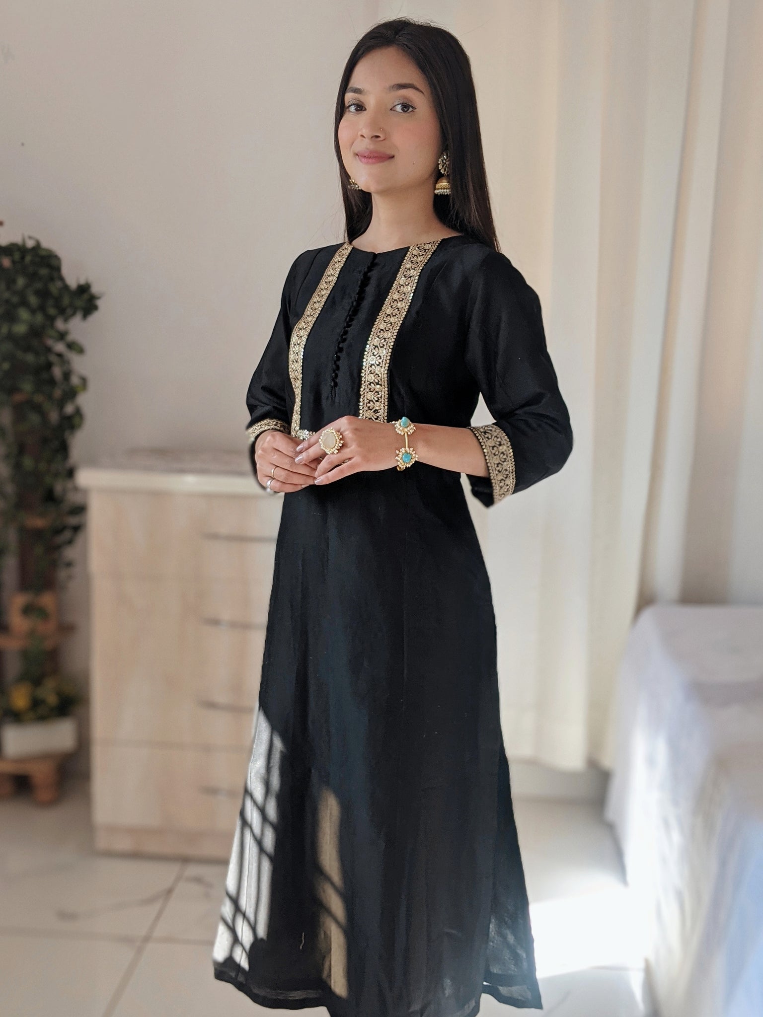 Black Silk Anarkali Kurta paired with pants.